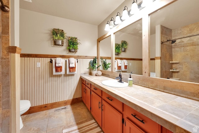 8135 S Clover Spring Ln E, Cottonwood Heights, UT 84121 - bathroom with toilet, vanity, and wainscoting