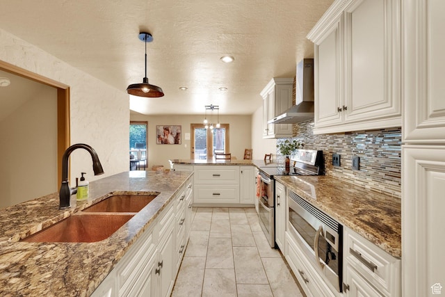 8135 S Clover Spring Ln E, Cottonwood Heights, UT 84121 - kitchen with wall chimney exhaust hood, stainless steel appliances, a sink, a peninsula, and tasteful backsplash