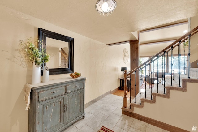 8135 S Clover Spring Ln E, Cottonwood Heights, UT 84121 - staircase featuring baseboards and a textured ceiling