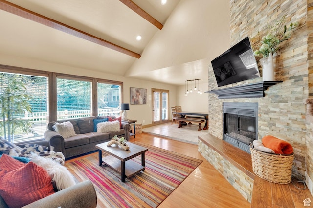 8135 S Clover Spring Ln E, Cottonwood Heights, UT 84121 - living area with a stone fireplace, beam ceiling, wood finished floors, high vaulted ceiling, and recessed lighting