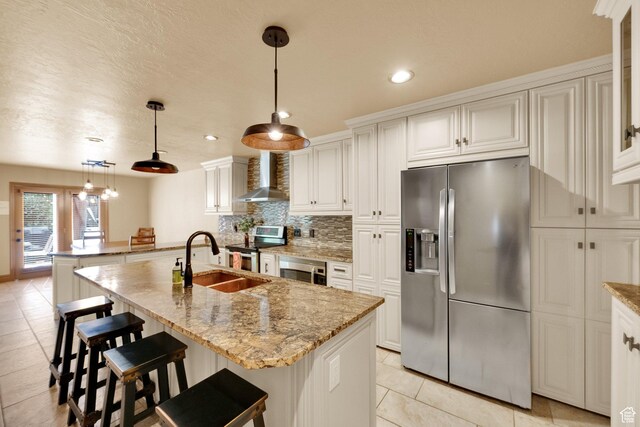8135 S Clover Spring Ln E, Cottonwood Heights, UT 84121 - kitchen featuring appliances with stainless steel finishes, wall chimney exhaust hood, a sink, decorative backsplash, and light tile patterned flooring