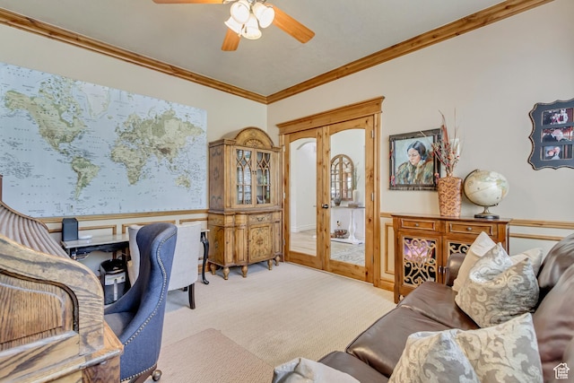 carpeted office with wainscoting, ornamental molding, and ceiling fan