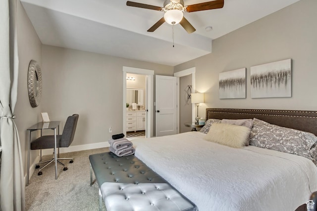 bedroom with carpet, baseboards, ensuite bathroom, and a ceiling fan