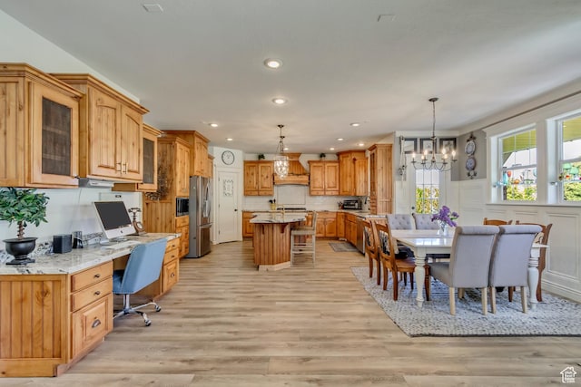 dining area with a chandelier, light wood-style flooring, and recessed lighting