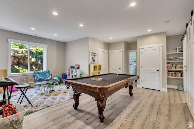 playroom with wood finished floors, billiards table, recessed lighting, and a barn door