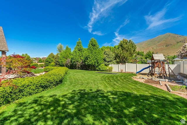 view of yard with a playground and a mountain view