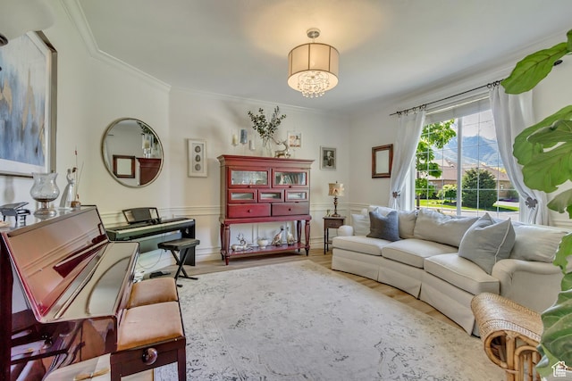 living room featuring wood finished floors, crown molding, and wainscoting