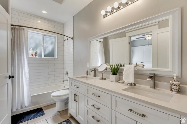 full bathroom with shower / bath combination with curtain, double vanity, a ceiling fan, tile patterned flooring, and toilet