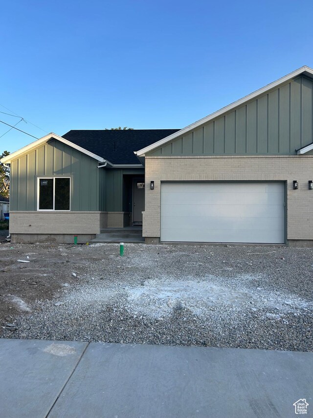 244 E 300 N, Payson, UT 84651 - view of front of property with board and batten siding, brick siding, an attached garage, and driveway