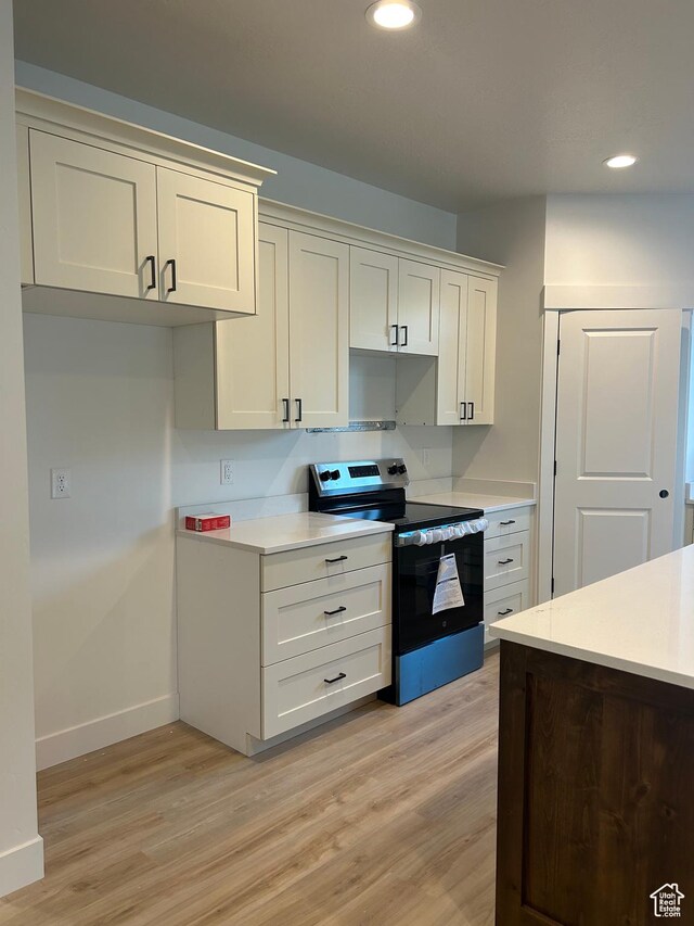 244 E 300 N, Payson, UT 84651 - kitchen featuring stainless steel electric range oven, light wood-type flooring, recessed lighting, light countertops, and white cabinetry