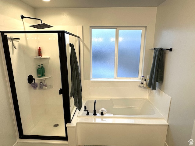 full bath with a shower stall and a garden tub