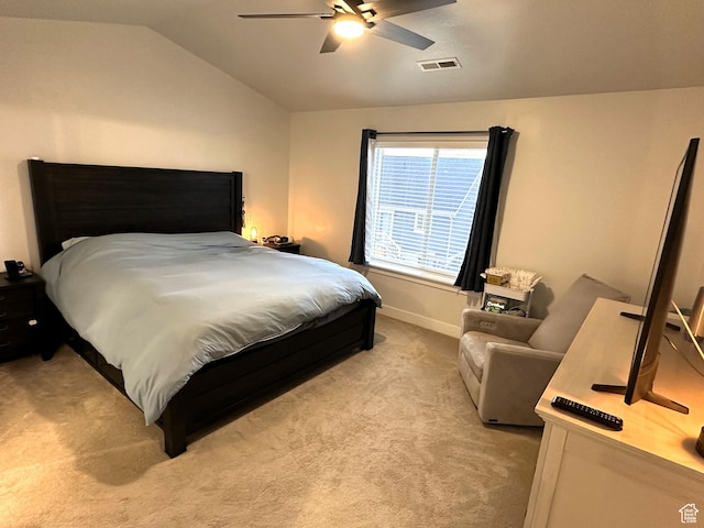bedroom with light carpet, vaulted ceiling, ceiling fan, and baseboards