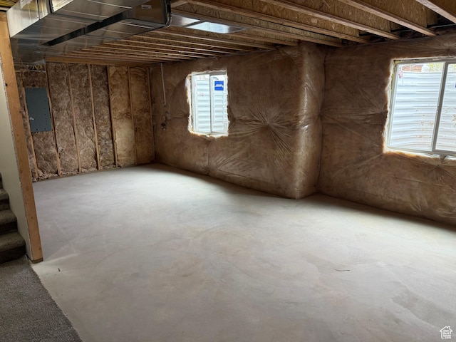 misc room featuring concrete floors and electric panel