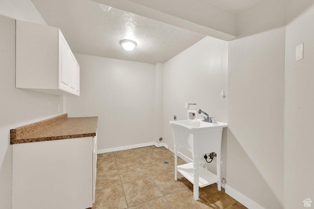 1159 E 5700 S, South Ogden, UT 84405 - laundry room with hookup for a washing machine, electric dryer hookup, a textured ceiling, baseboards, and cabinet space