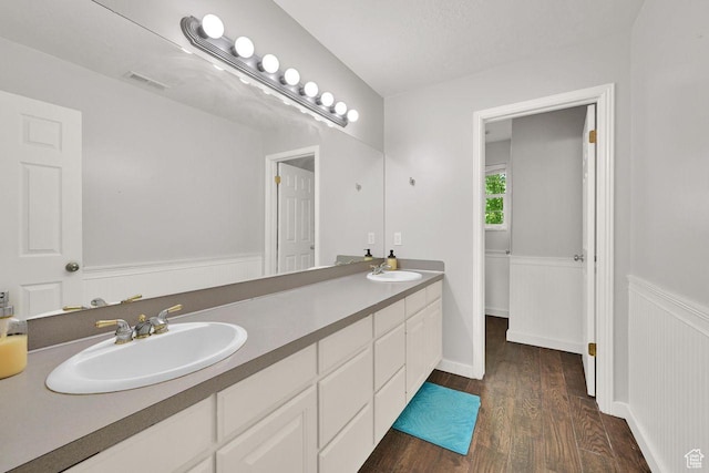 1159 E 5700 S, South Ogden, UT 84405 - full bath with wood finished floors, double vanity, and a wainscoted wall
