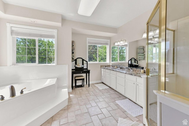 1159 E 5700 S, South Ogden, UT 84405 - full bathroom featuring vanity, stone finish flooring, a stall shower, a garden tub, and baseboards