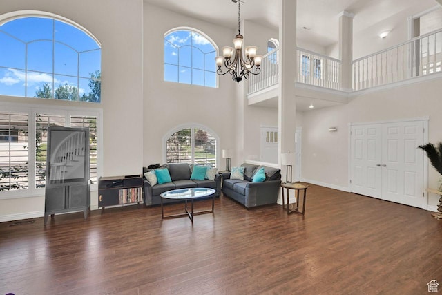1159 E 5700 S, South Ogden, UT 84405 - living room featuring a towering ceiling, dark wood-style floors, a chandelier, and baseboards