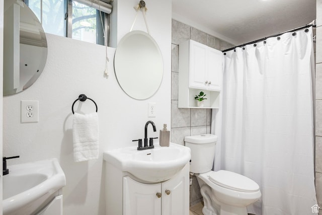 full bath with tile walls, toilet, vanity, and a shower with shower curtain