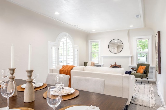 carpeted living room featuring plenty of natural light, baseboards, and recessed lighting