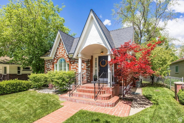 tudor house with brick siding and roof with shingles