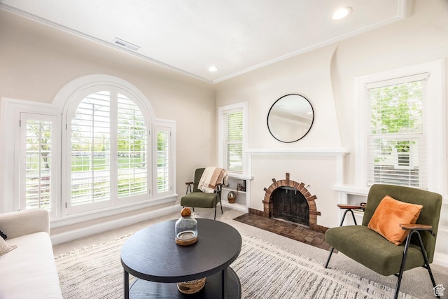 carpeted living area with healthy amount of natural light, a fireplace, baseboards, and recessed lighting