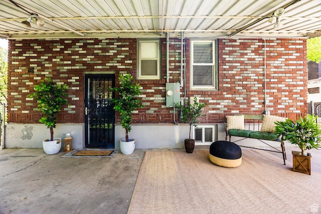 doorway to property with brick siding