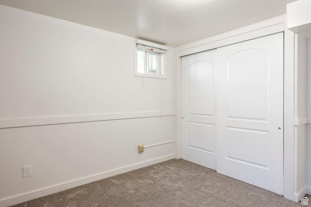 below grade area featuring carpet flooring and baseboards