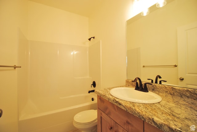 bathroom featuring bathing tub / shower combination, toilet, and vanity