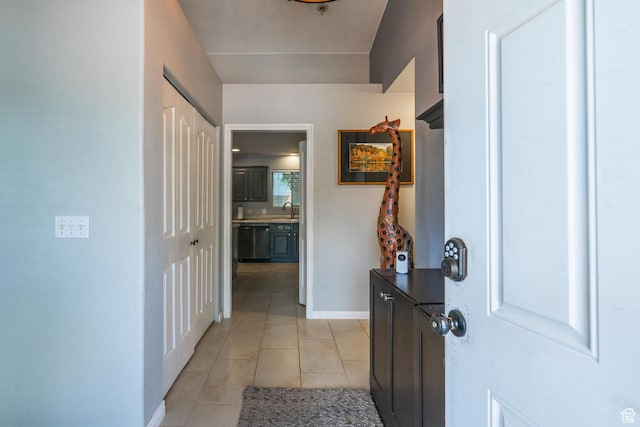 foyer entrance featuring light tile patterned floors and baseboards