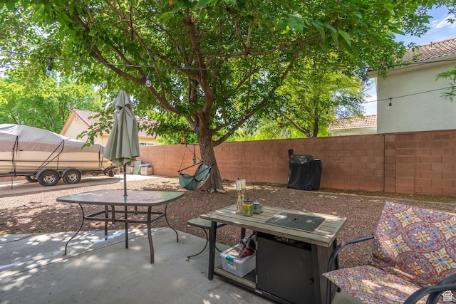 view of patio featuring fence