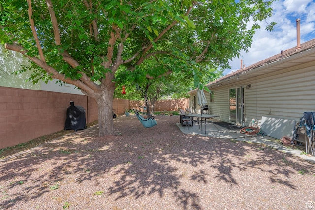 fenced backyard with a patio area