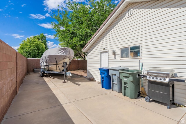 view of patio with a grill and a fenced backyard
