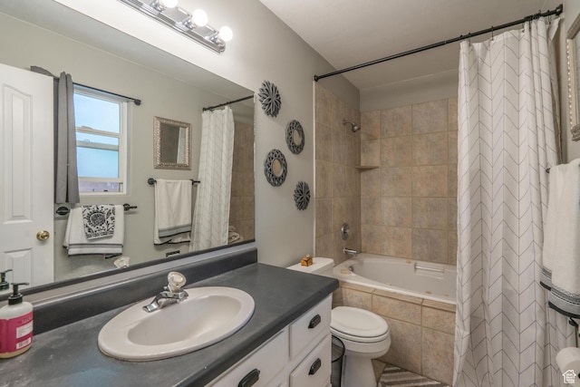 full bathroom with tiled shower / bath combo, vanity, and toilet