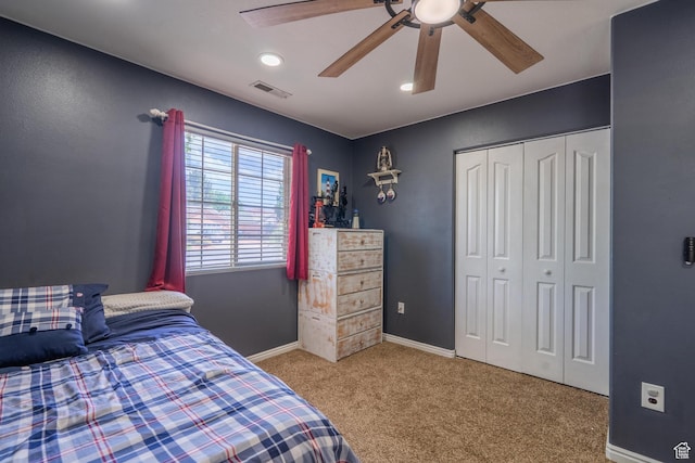 bedroom featuring carpet, a closet, baseboards, and ceiling fan