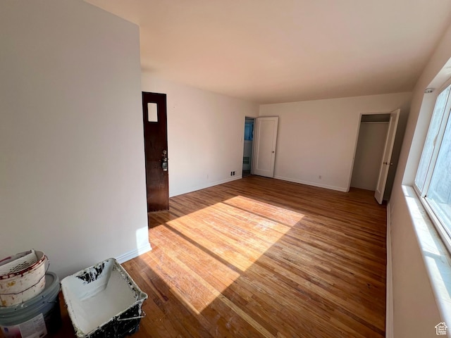 unfurnished room featuring wood finished floors and baseboards