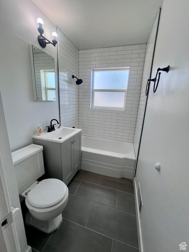 bathroom featuring tile patterned floors, toilet, bathtub / shower combination, and vanity