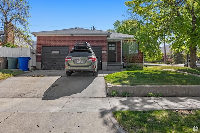 view of front facade featuring driveway, a garage, and brick siding