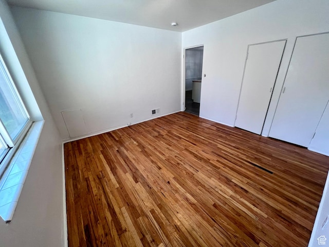 unfurnished bedroom with hardwood / wood-style flooring