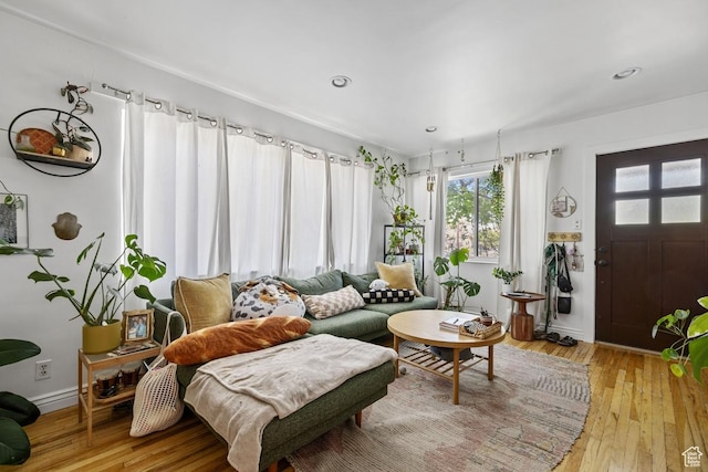 living room featuring hardwood / wood-style floors, baseboards, and recessed lighting