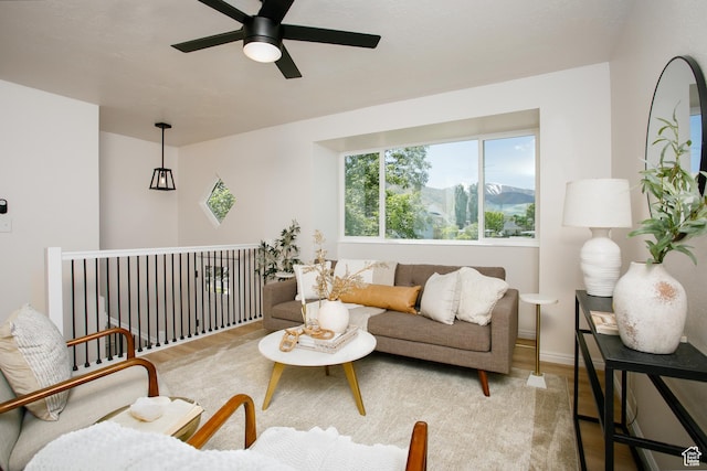 living room with ceiling fan and a mountain view