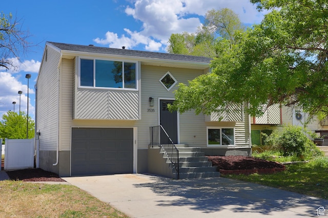 raised ranch with a garage and driveway