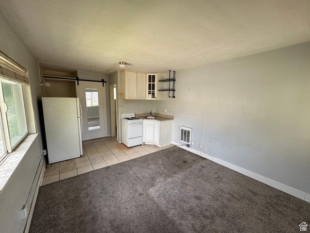 241 N 800 W, Salt Lake City, UT 84116 - kitchen with white appliances, a sink, open shelves, a barn door, and light colored carpet