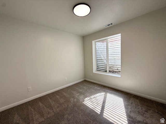 spare room with carpet floors and baseboards