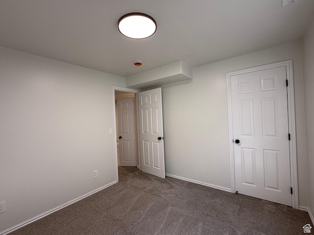 unfurnished bedroom with carpet flooring and baseboards