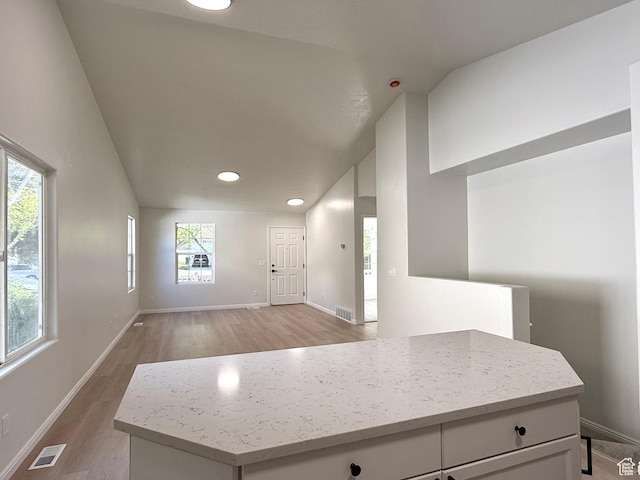 entryway featuring light wood finished floors, baseboards, recessed lighting, and lofted ceiling