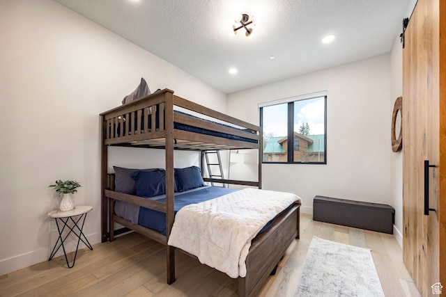 9335 N Canopy Ln E, Sundance, UT 84604 - bedroom with light wood-style floors, baseboards, recessed lighting, and a textured ceiling
