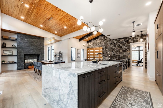 9335 N Canopy Ln E, Sundance, UT 84604 - kitchen with a sink, modern cabinets, a large island with sink, light wood-type flooring, and wooden ceiling