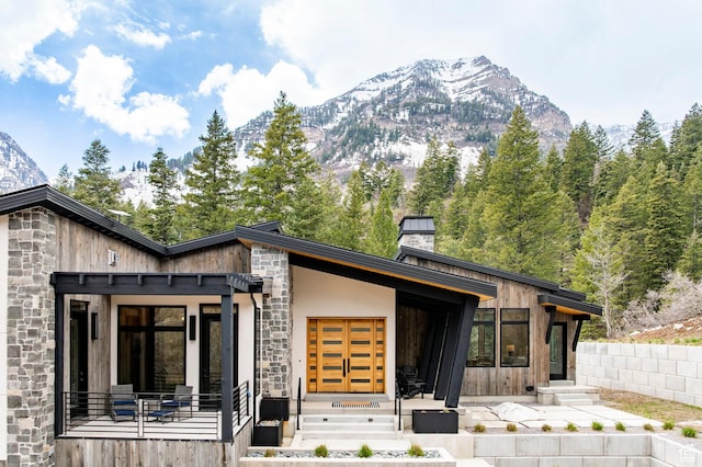 9335 N Canopy Ln E, Sundance, UT 84604 - rear view of property with stone siding, a mountain view, and a chimney