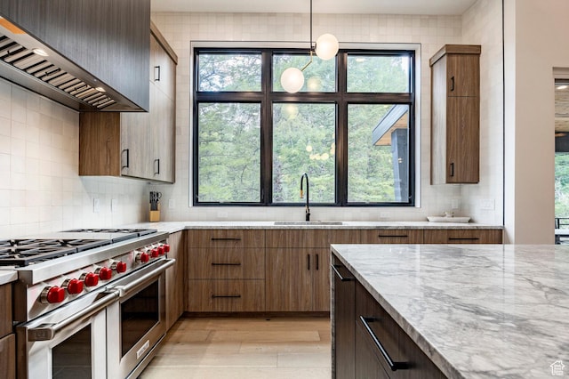 9335 N Canopy Ln E, Sundance, UT 84604 - kitchen with double oven range, custom range hood, a sink, light wood finished floors, and backsplash