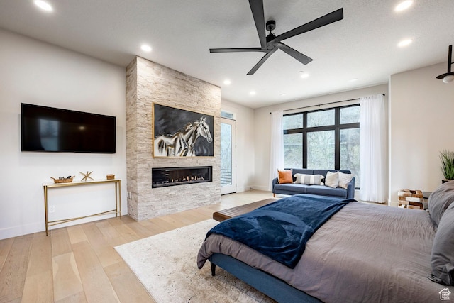 9335 N Canopy Ln E, Sundance, UT 84604 - bedroom with wood-type flooring, a stone fireplace, recessed lighting, baseboards, and ceiling fan